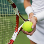 Tennis player holding racket and ball in hands